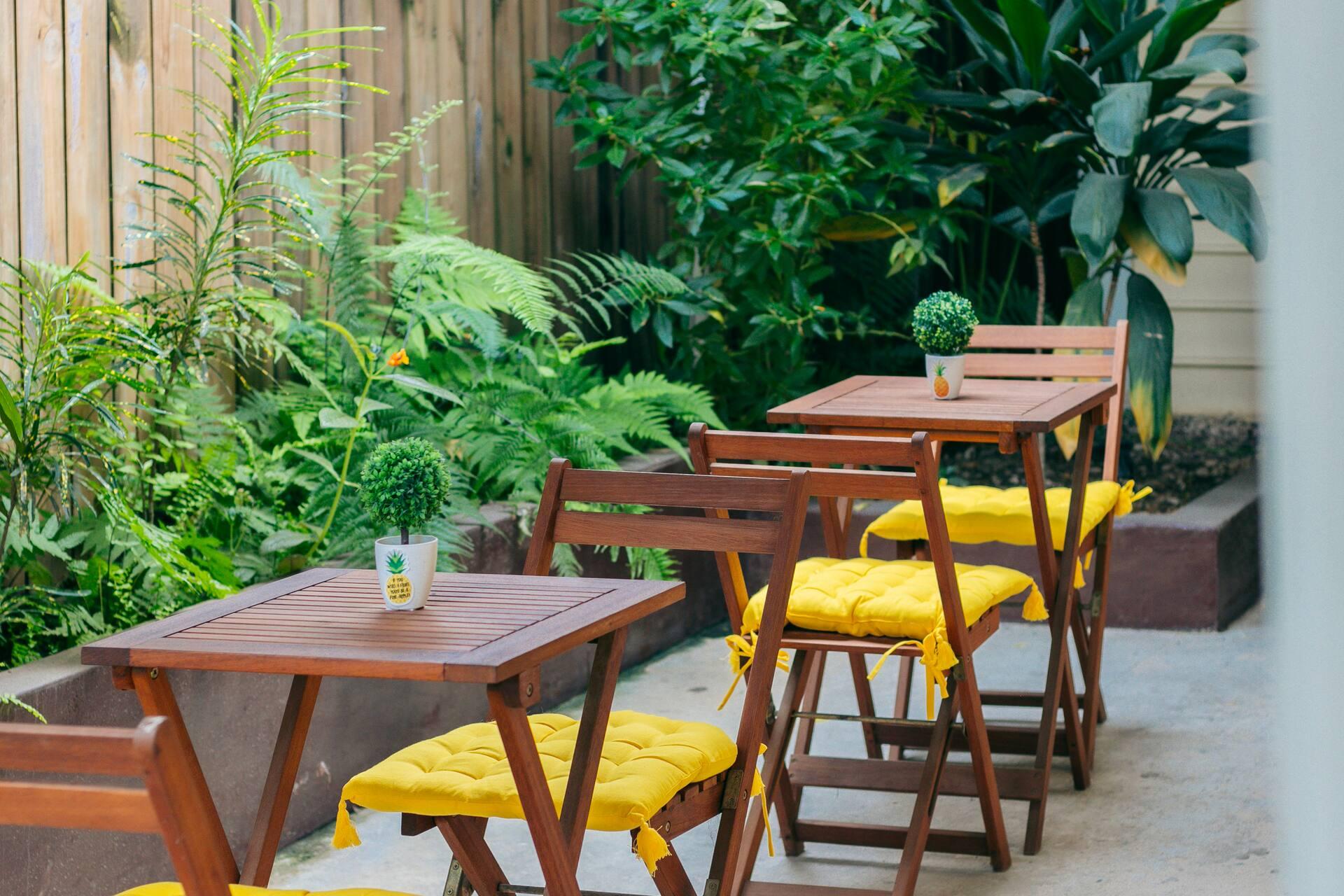 Bistro tables set among the plants in the courtyard