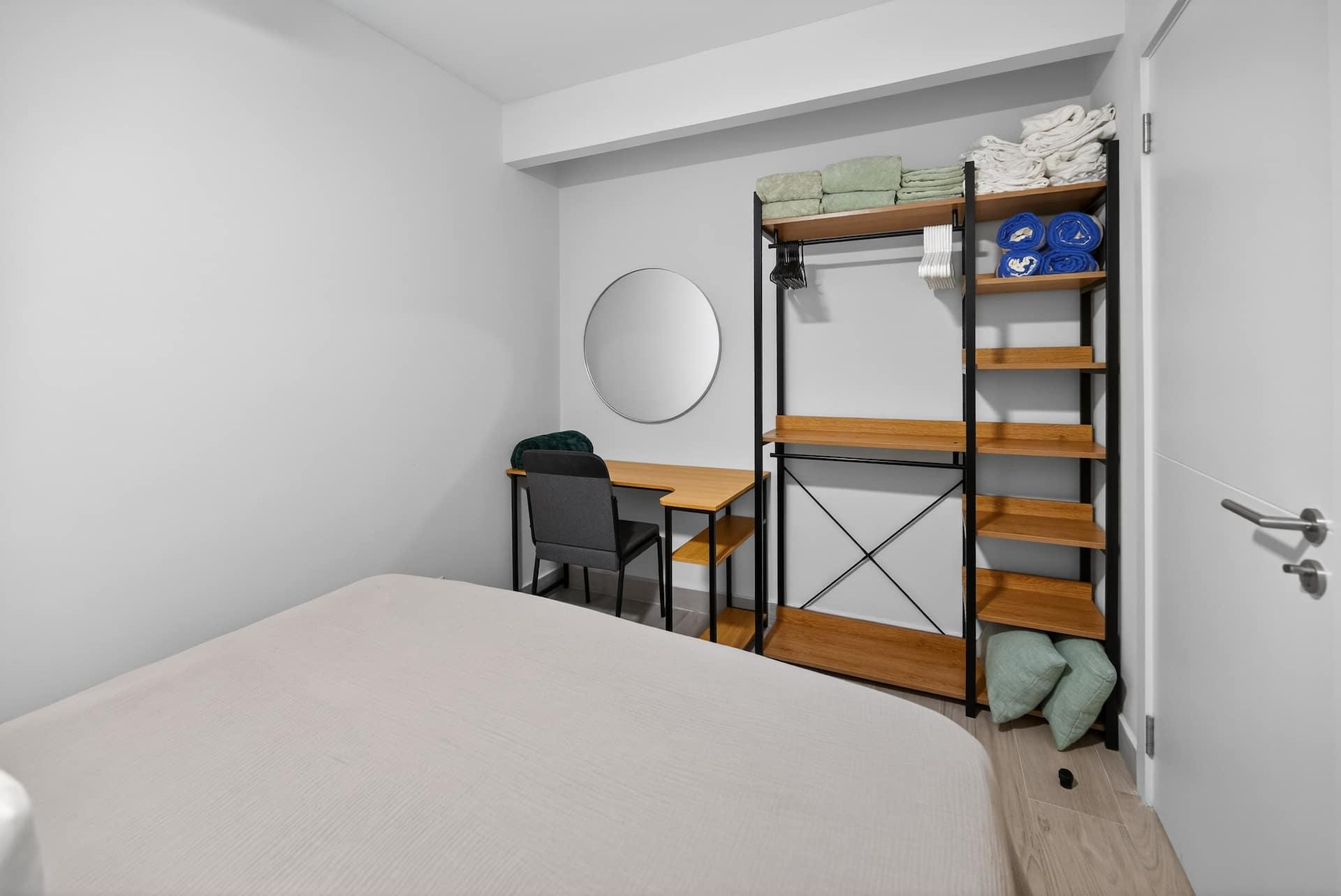 The desk and shelving in the bedroom, set up for working