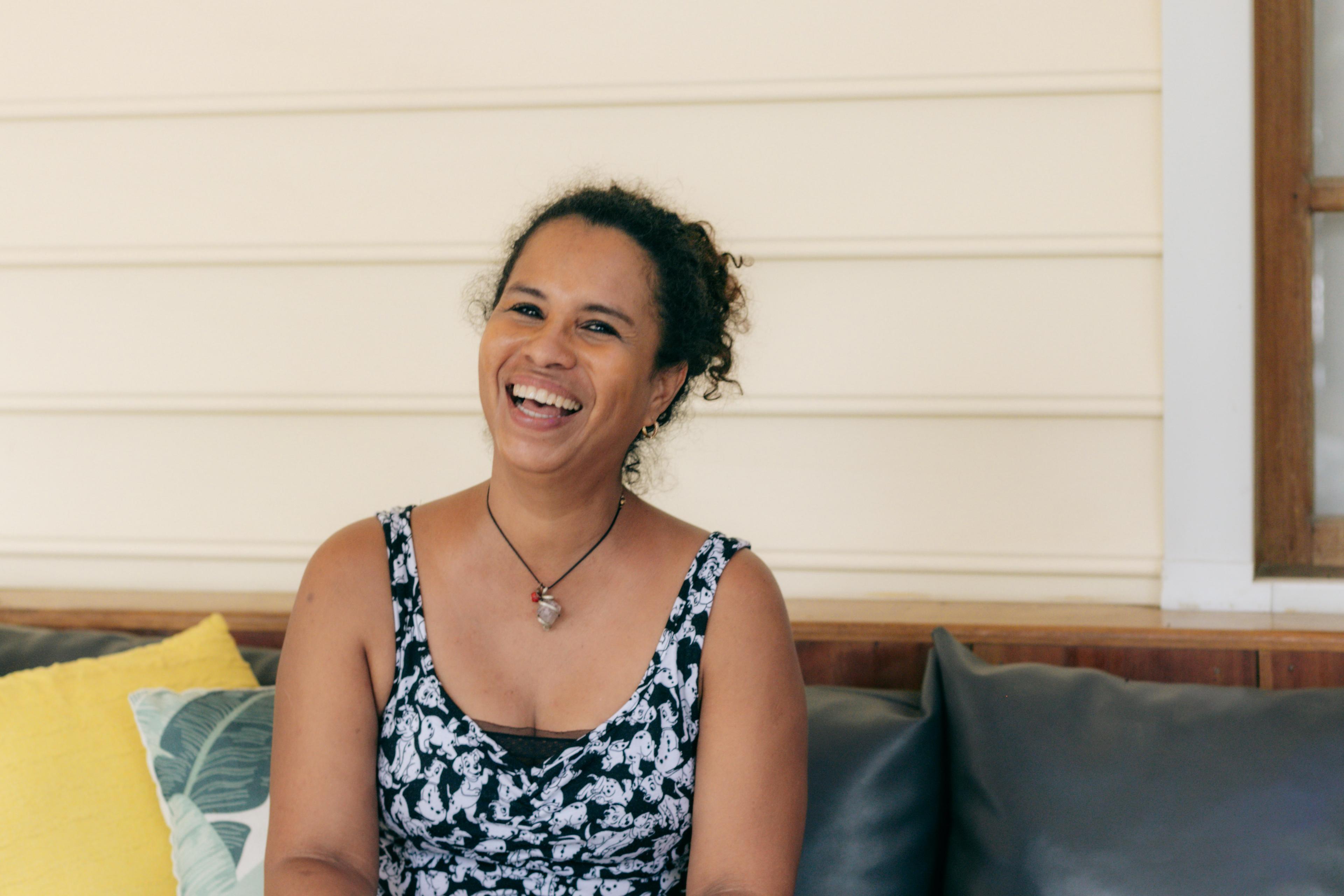 Mabel laughing on the lounge sofa at Pineapple House in Bocas del Toro